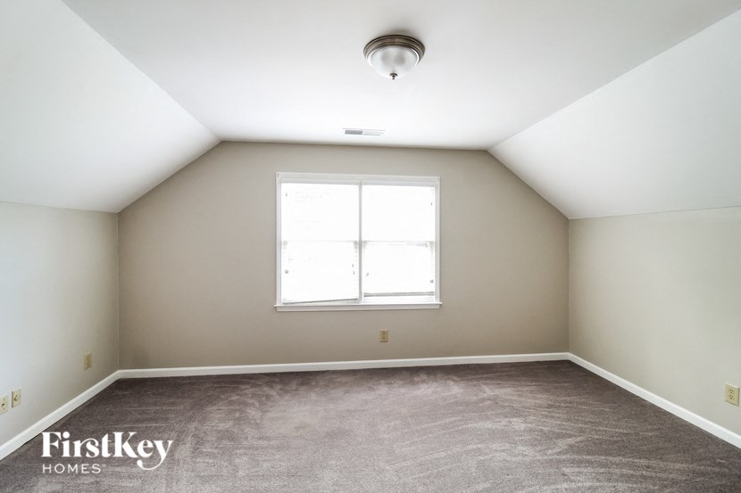 a large room with carpet and a window