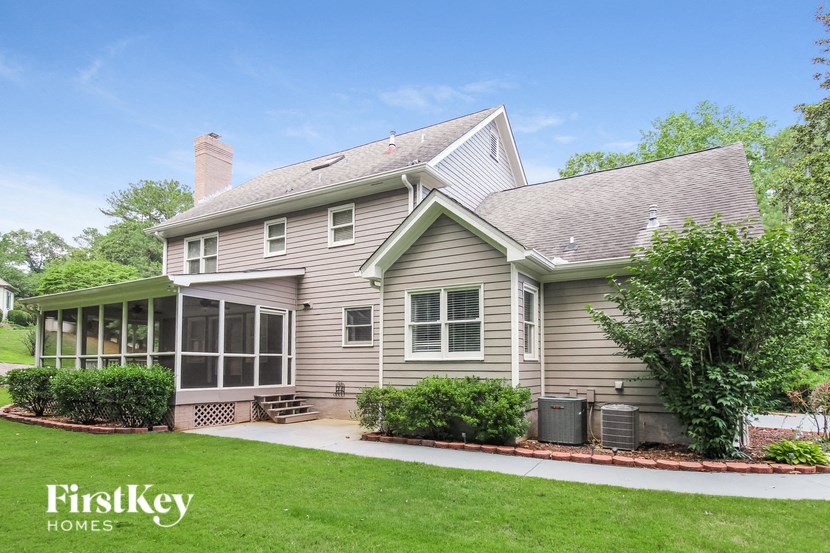 a home with a green lawn and a covered porch