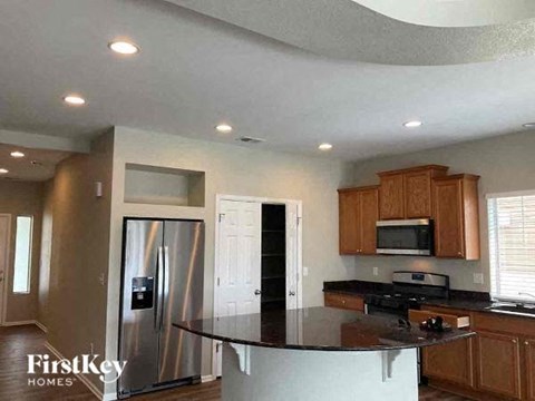 a kitchen with a counter top and a stainless steel refrigerator