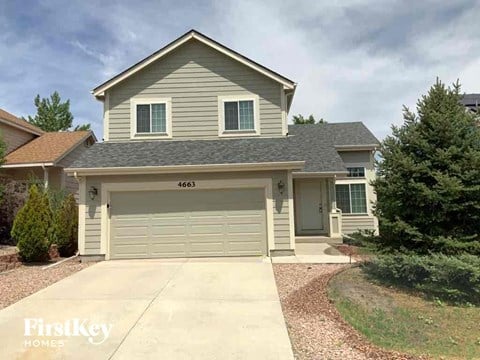 A house with a garage door numbered 4663 is for sale.