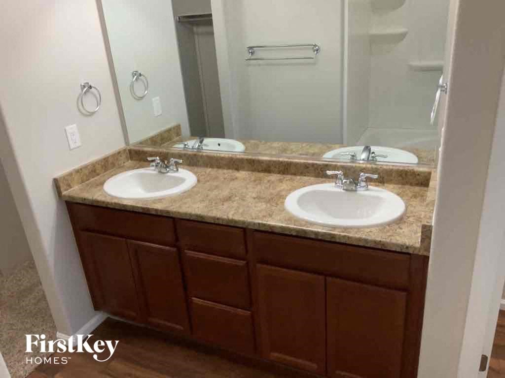 A bathroom with two sinks and a mirror.