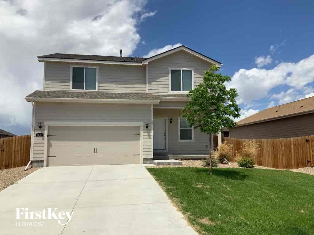 A two-story house with a garage is for sale.