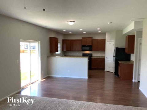 A kitchen with wooden cabinets and a white counter.