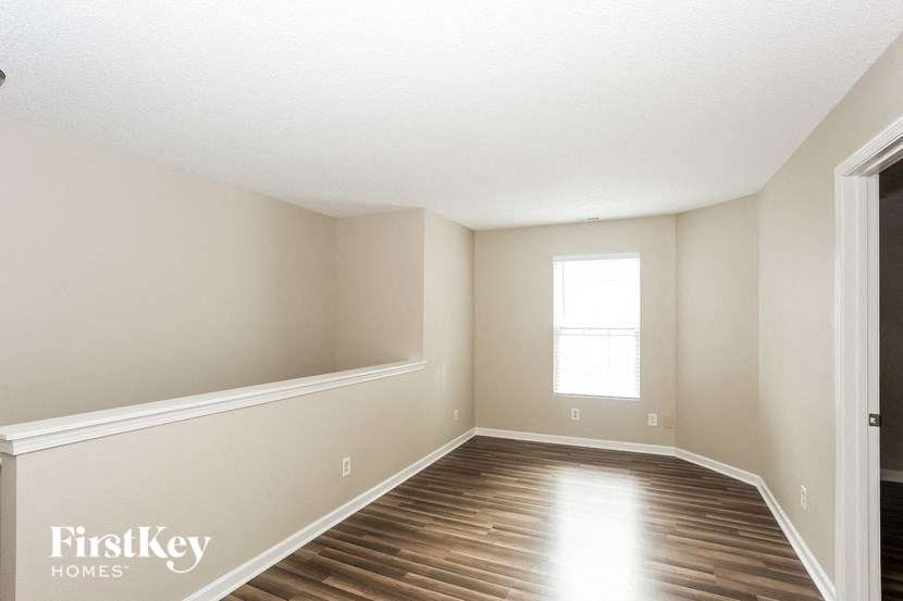 a empty room with wooden floors and a window