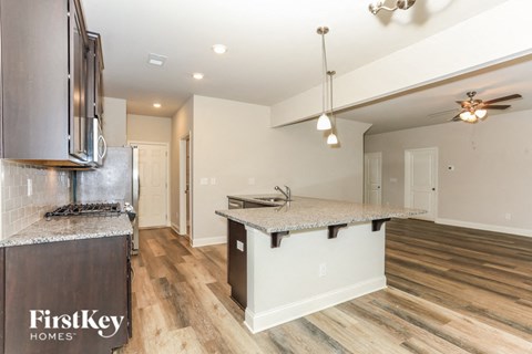 A kitchen with a stove top oven and a counter top.