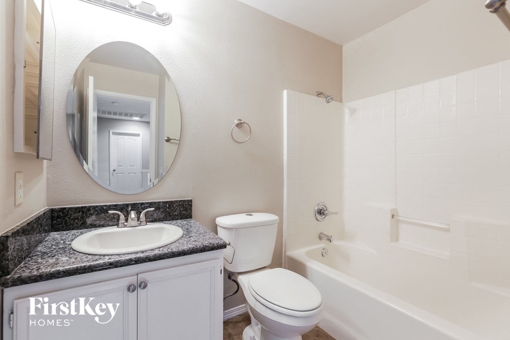 a white bathroom with a sink toilet and bath tub