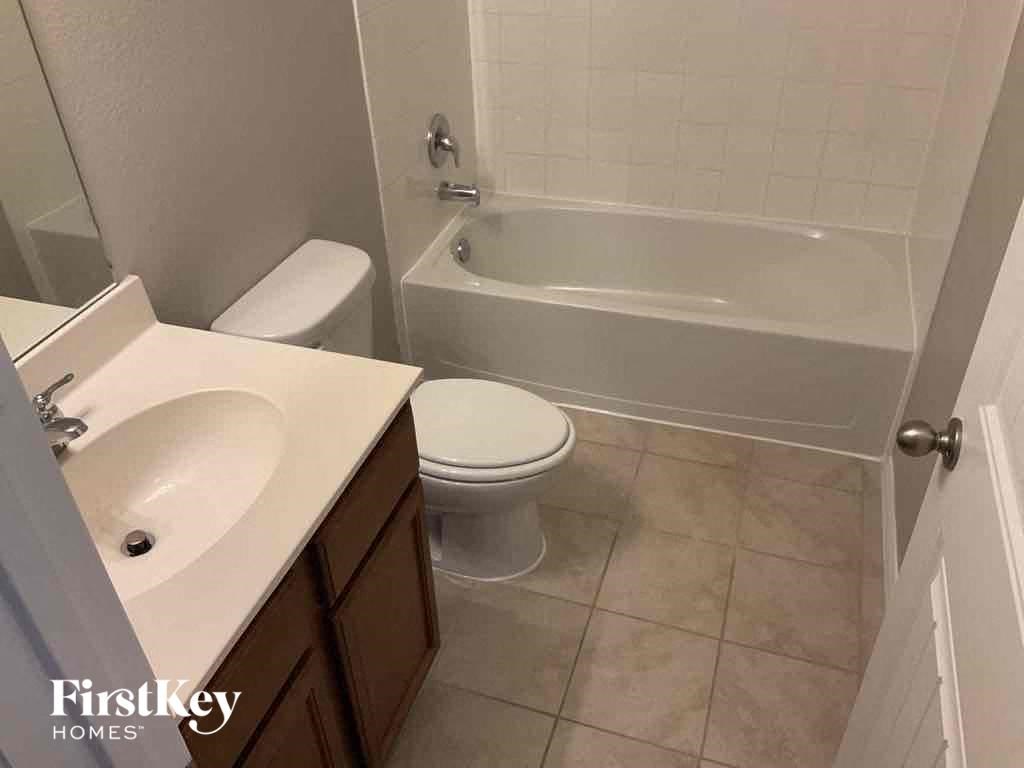 a bathroom with a sink toilet and a bath tub