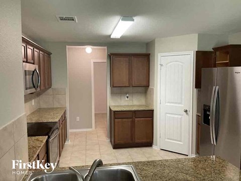 a kitchen with a sink and a refrigerator