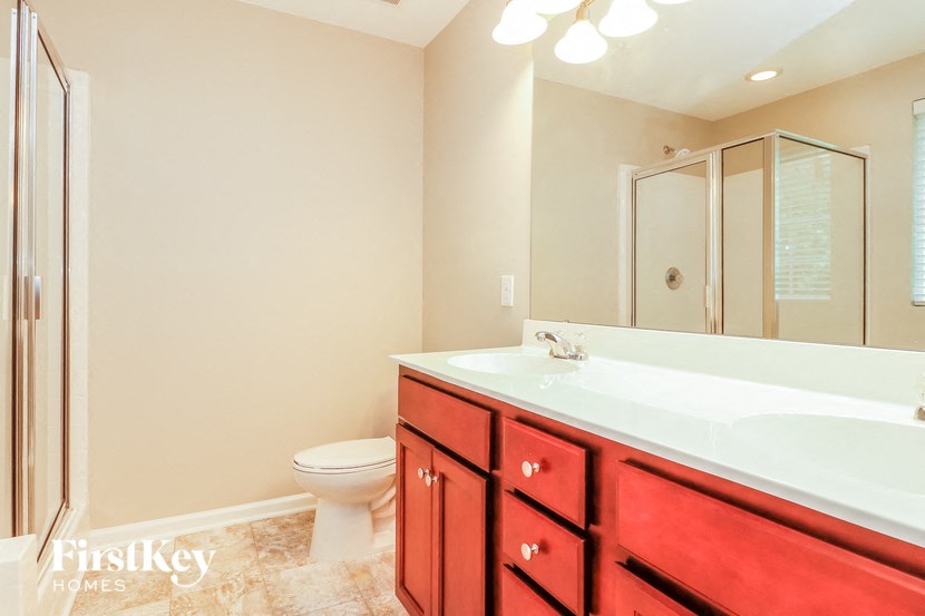a bathroom with a sink toilet and a mirror