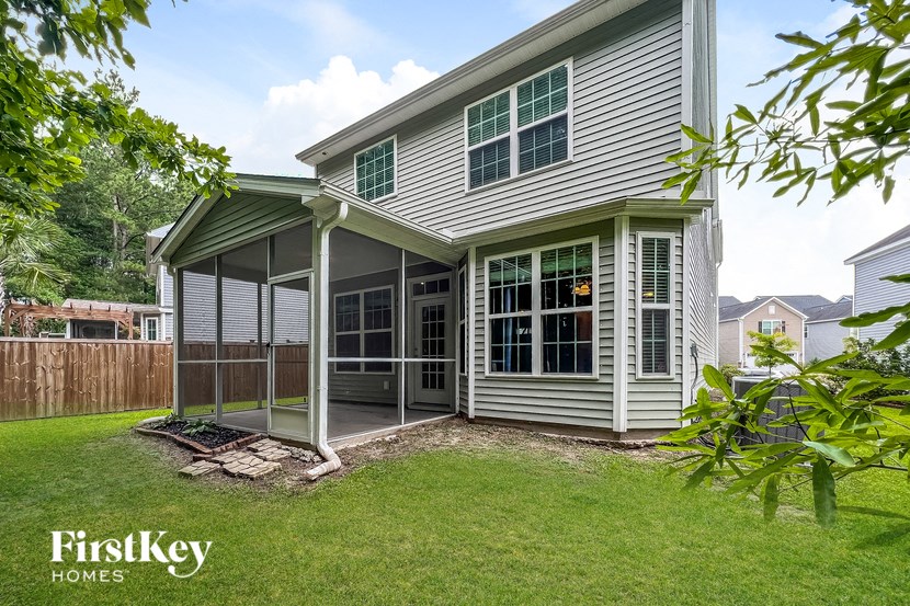 a white house with a patio and a yard