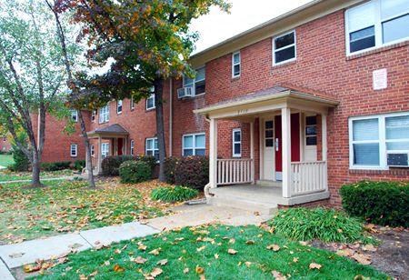 the front of a brick house with a porch