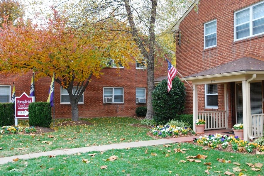 a brick house with an flag in front of it