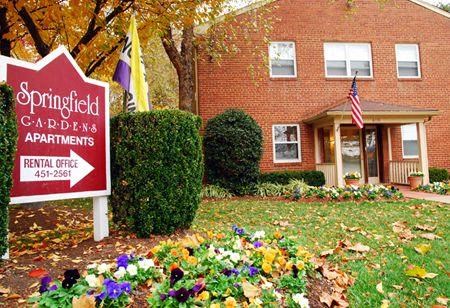 a yard with a sign in front of a house