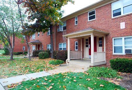 the front of a brick house with a porch