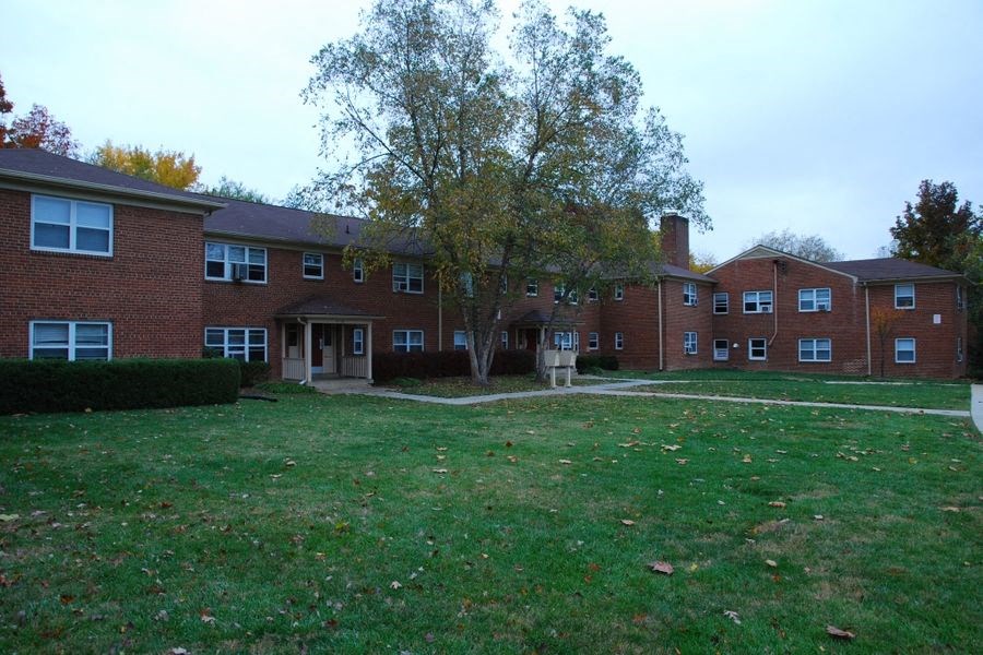 a large brick building with green grass in front of it