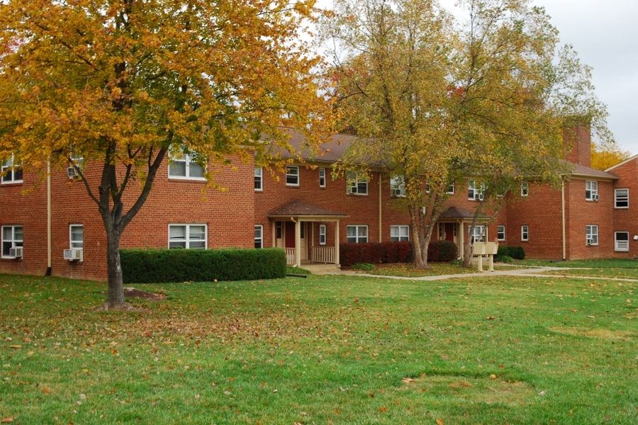 a large brick building with trees in front of it