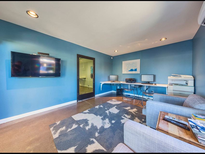 a living room with a blue wall and a tv