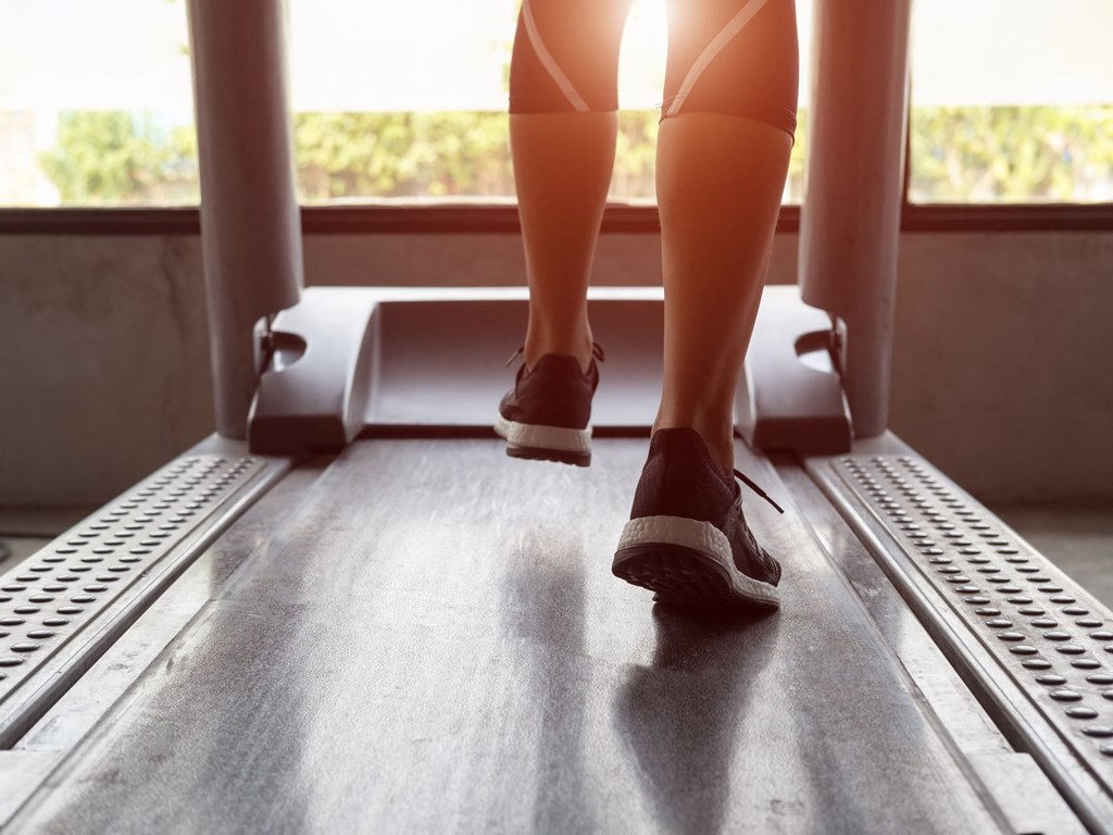 a woman walking on a treadmill on a train