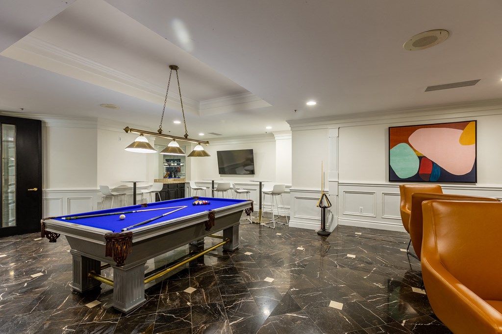 a billiards room with a blue pool table