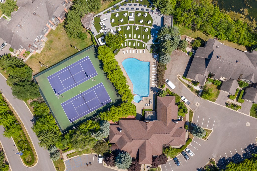 arial view of a house with a tennis court and a swimming pool