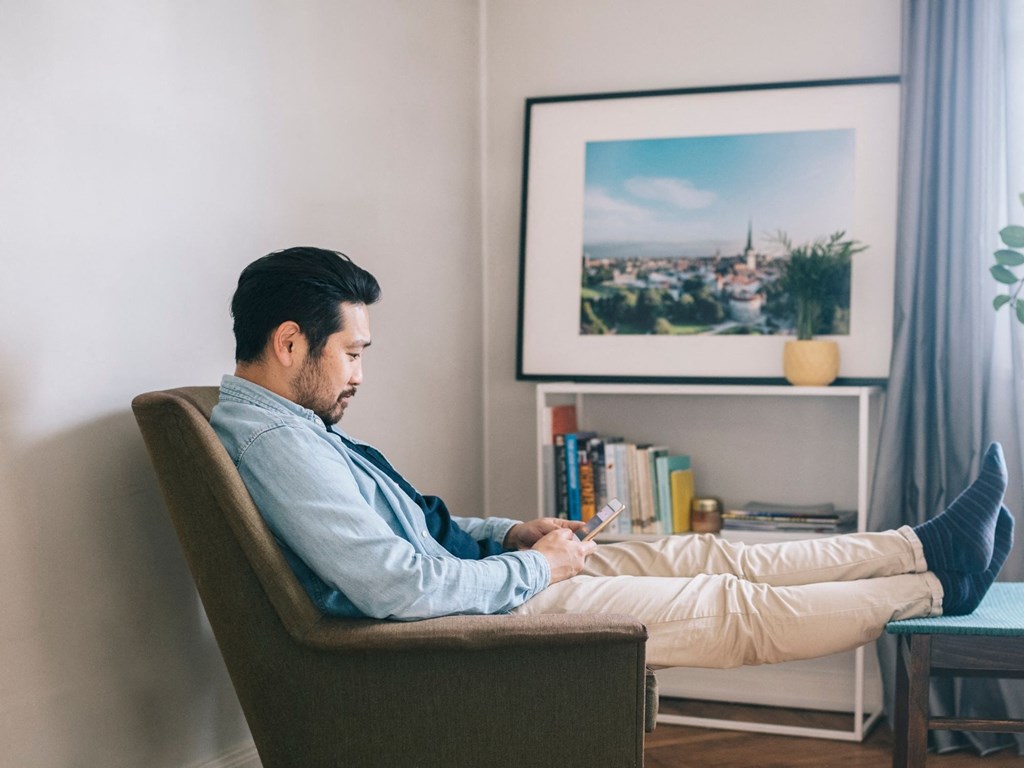 a man sitting in a chair with his feet up on a table