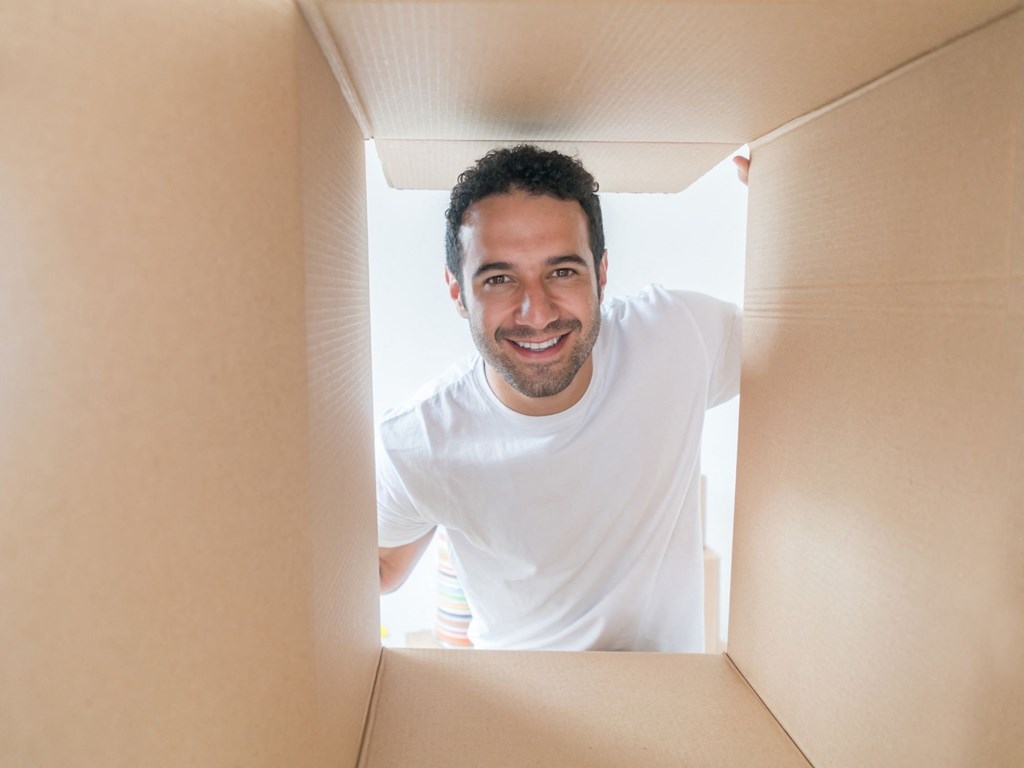 a man standing in a box looking into a box