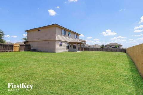 A house with a fence and a grassy yard.