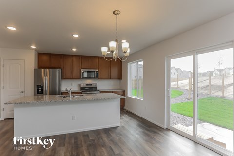 A modern kitchen with a wooden cabinet and a white countertop.