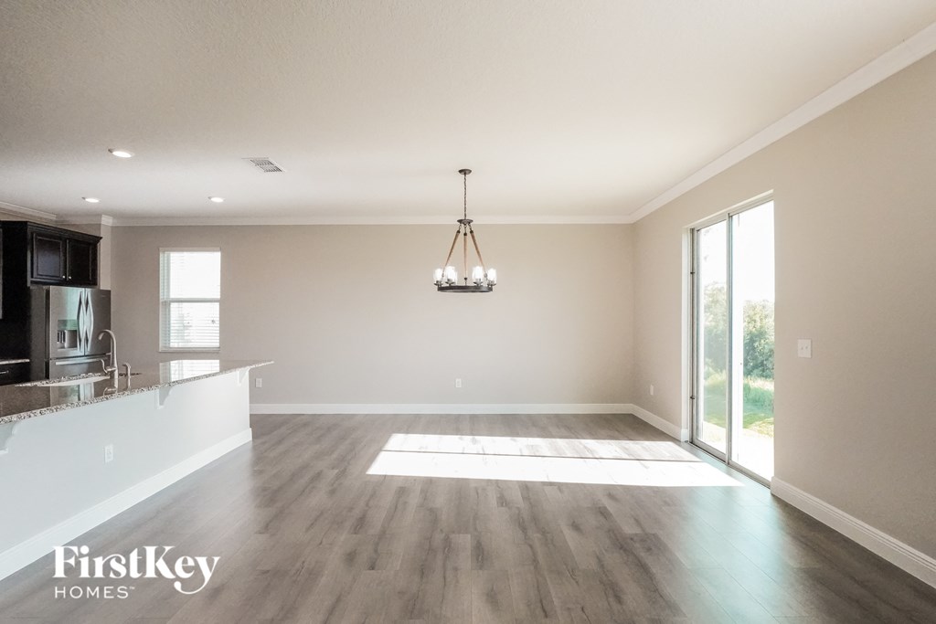 an empty living room and kitchen in a new home