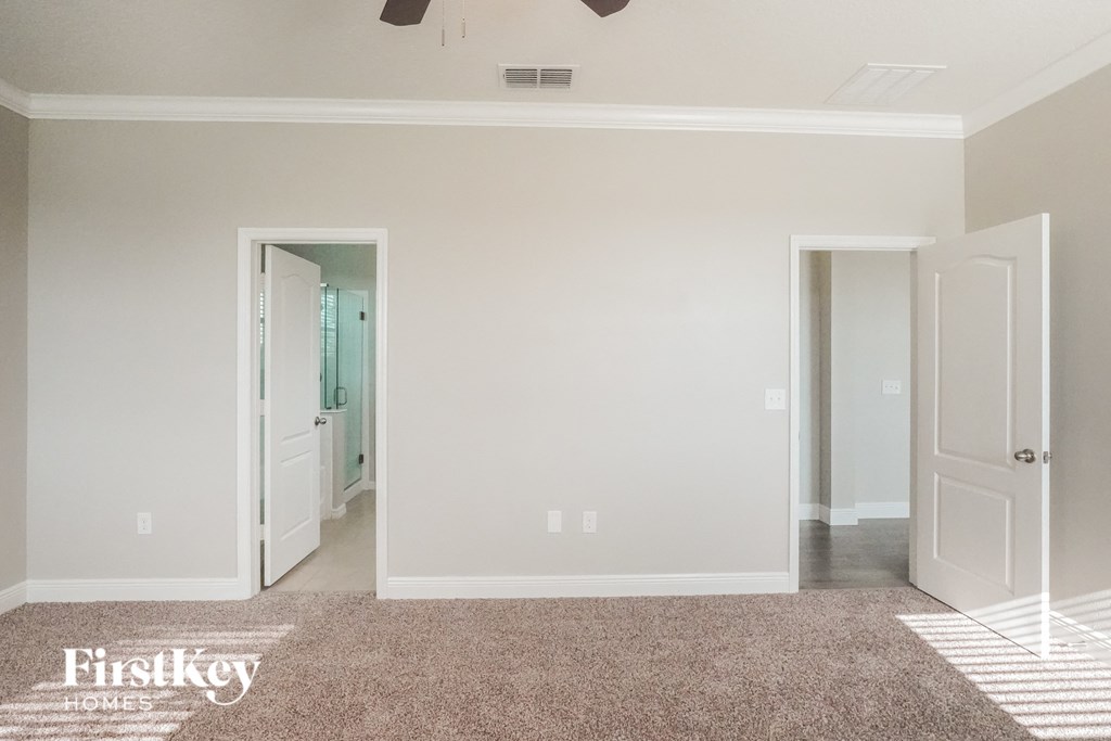 a living room with a carpet and a door to a bathroom