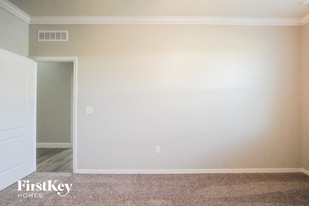 a empty room with a white wall and a door