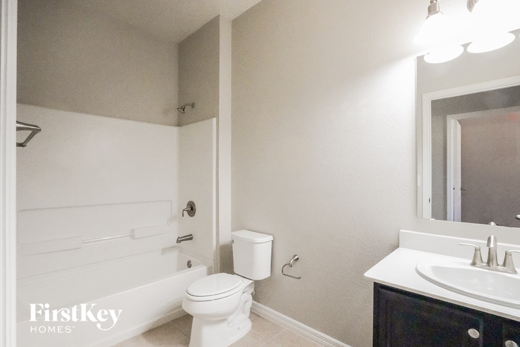 a bathroom with a sink toilet and a bath tub