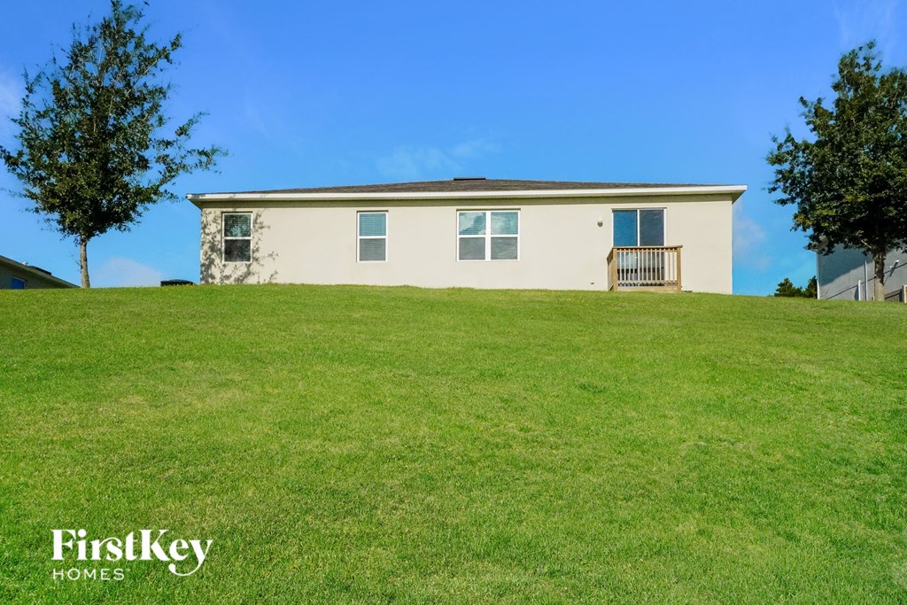 a house on top of a grass covered hill