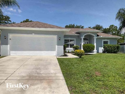 a house with a driveway and a white garage door