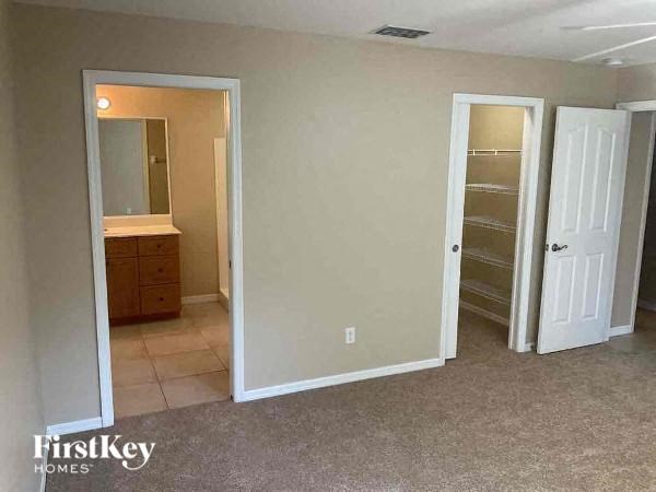 an empty bathroom with a sink and a closet