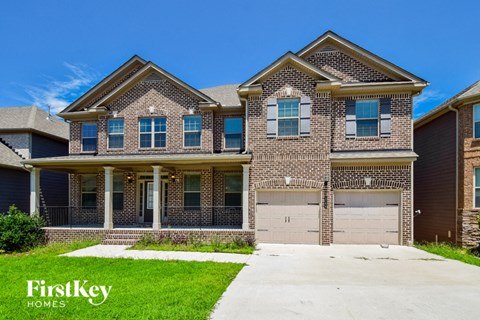 a large brick house with two garage doors
