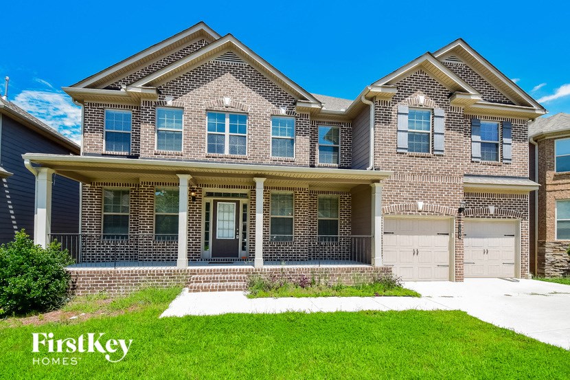 a large brick house with a lawn in front of it
