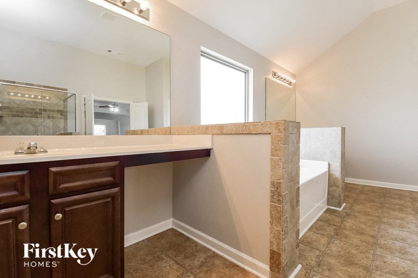 a bathroom with a sink and a mirror and a tub
