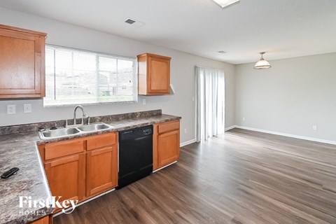 a kitchen and living room with wood flooring and a sink