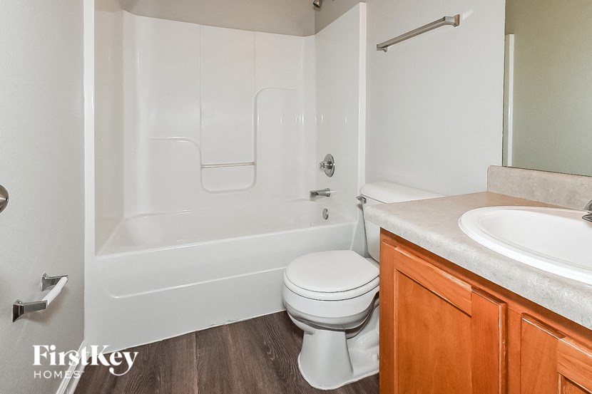 a white bathroom with a toilet and a sink