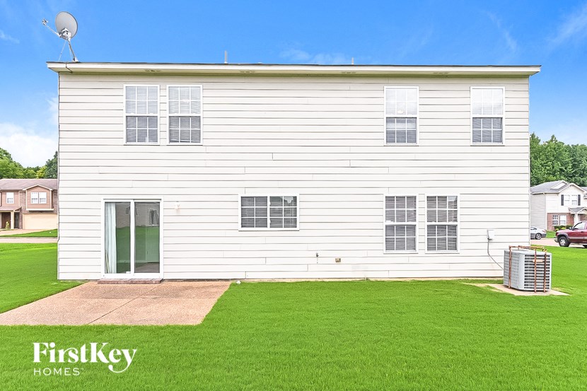 a white house with a lawn in front of it