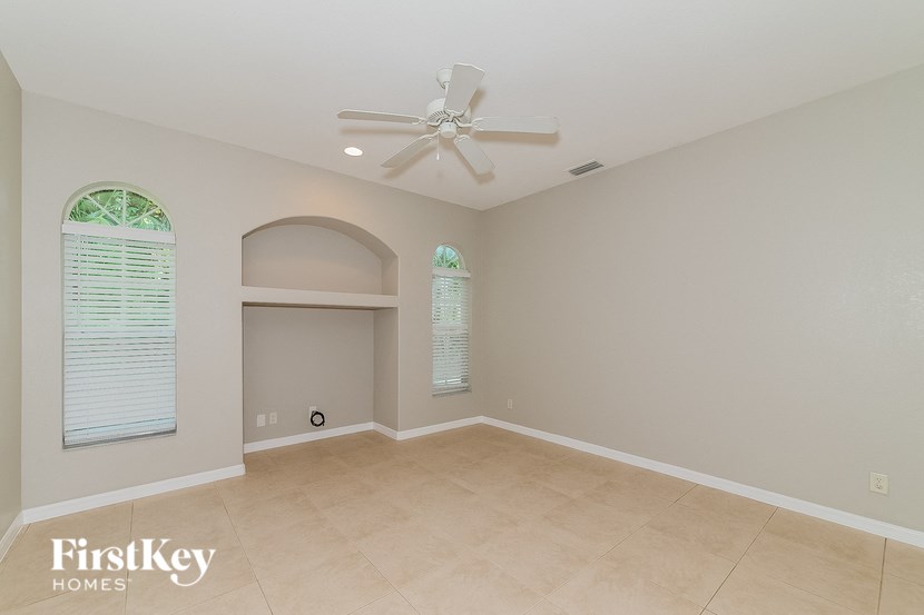a empty living room with a ceiling fan