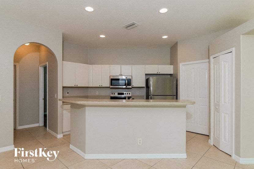 a kitchen with a counter top and a refrigerator