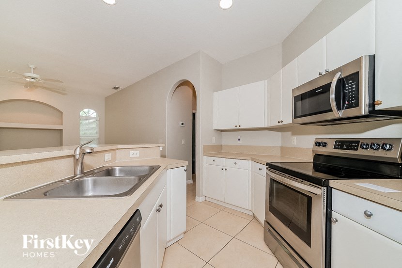 a kitchen with stainless steel appliances and white cabinets