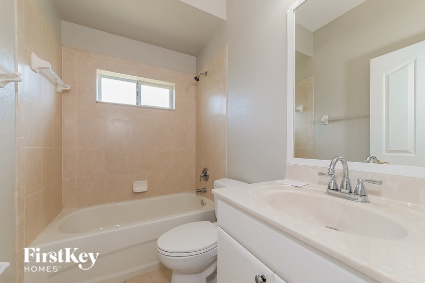 a bathroom with a sink toilet and a bath tub