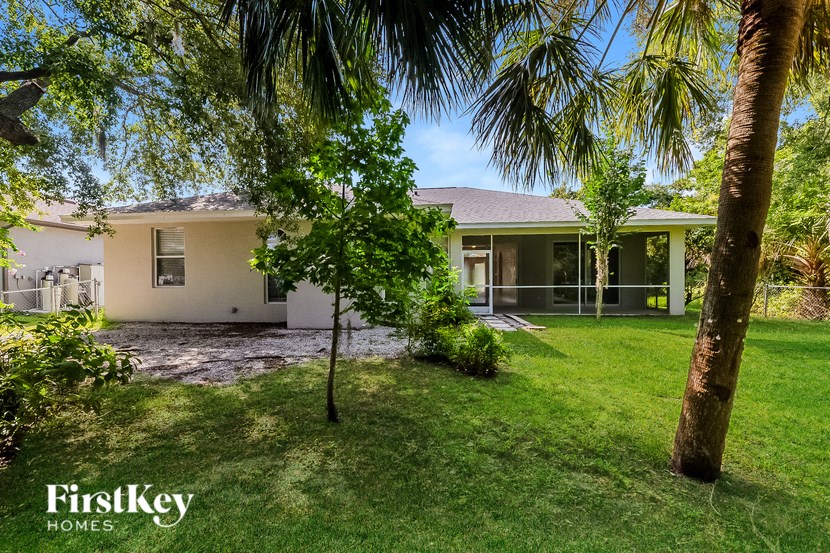 a house with a yard and palm trees