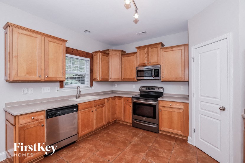 a kitchen with wooden cabinets and stainless steel appliances