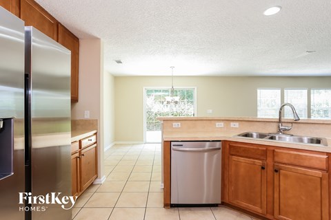a kitchen with wooden cabinets and stainless steel appliances