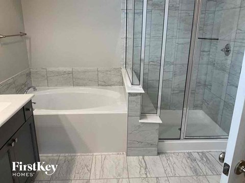 a small bathroom with a tub and a shower