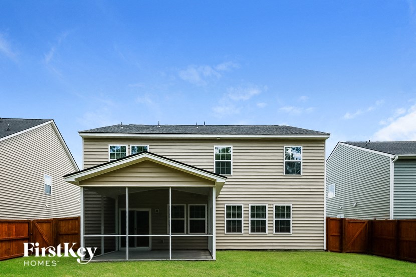 A house with a covered patio is for sale by FirstKey Homes.